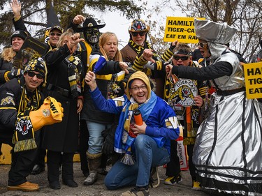 A group of Hamilton Tiger-Cats fans get photobombed by Winnipeg Blue Bombers fan Michael Hughes as fans head to McMahon Stadium for the Grey Cup on Sunday, November 24, 2019. Azin Ghaffari/Postmedia Calgary