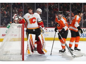 Michael Raffl of the Philadelphia Flyers looks after Flames goalie David Rittich after they collided during the second period at the Wells Fargo Center on Saturday in Philadelphia.