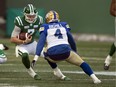 Saskatchewan Roughriders quarterback Cody Fajardo (7) runs the ball against Winnipeg Blue Bombers linebacker Adam Bighill (4) in Sunday's West final.