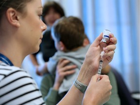 A flu vaccination is prepared at the South Health Calgary Health Centre on the first day of immunization clinics across the city, Monday October 23, 2017.  Gavin Young/Postmedia