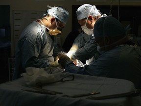 The kidney of Tracey Playfair is implanted in the groin area of her sister by a surgeon and his team during a live donor kidney transplant at The Queen Elizabeth Hospital Birmingham on June 9, 2006, in Birmingham, England.