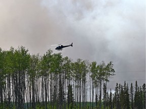 A helicopter seen approximately three kilometres southwest of High Level where about 4,000 residents were evacuated from the Chuckegg Creek fire on May 23, 2019.