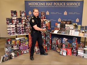 Staff Sgt. Cory Both of the Medicine Hat police shows off a $30,000 haul of toys and DVDS obtained through allegedly fraudulent means. Supplied photo/Postmedia Calgary