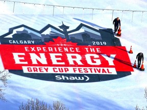 Ice crew cordon off the Grey Cup Festival logo recently added to the ice at Olympic Plaza while they waited to add more layers of ice before the Grey Cup's arrival in the plaza on Tuesday.