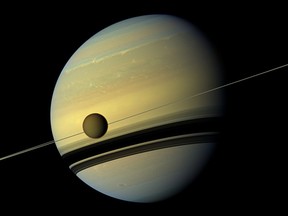 (FILES) This file photo taken on August 31, 2012 shows a giant of a moon appearing before a giant of a planet undergoing seasonal changes in this natural color view of Titan and Saturn from NASA's Cassini spacecraft.