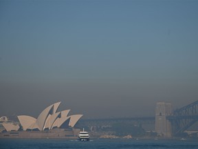 Smoke from bushfires blanket Sydney on November 19, 2019. - Sydney woke up to a thick blanket of smoke as New South Wales warns residents of the dangers amid severe fire dangers and hot, windy weather. Bushfire-prone Australia has experienced a horrific start to its fire season, which scientists say is beginning earlier and becoming more extreme as a result of climate change, which is raising temperatures and sapping moisture from the environment. (Photo by PETER PARKS / AFP) (Photo by PETER PARKS/AFP via Getty Images)