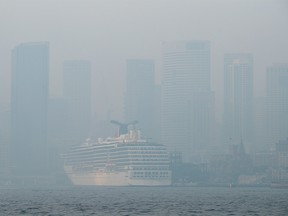 The Sydney Harbour and central business district (CBD) are shrouded in haze in Sydney, Australia, on Thursday, Nov. 21, 2019. Sydney was shrouded by smoke for a second time this week as bushfires continued to rage along Australia’s eastern seaboard. Early morning commuters in the city center were faced with an acrid haze that stung the eyes and blanketed landmarks. Photographer: Brendon Thorne/Bloomberg ORG XMIT: 775440882