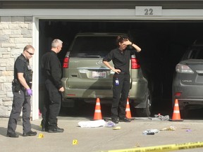 Crime scene police examine evidence at a home at 22 Redstone Manor NE where 2 ppeople were killed on Sptember 21, 2016.