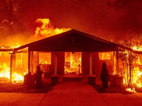 A home burns during the Camp fire in Paradise, California on November 8, 2018.