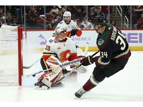 CP-Web.  Arizona Coyotes center Carl Soderberg (34) scores a goal against Calgary Flames goaltender David Rittich (33) as Flames defenseman Travis Hamonic (24) looks on during the second period of an NHL hockey game, Saturday, Nov. 16, 2019, in Glendale, Ariz.