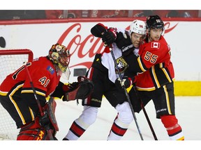 Calgary Flames Noah Hanifin battles against Magnus Paajarvi of the Ottawa Senators during NHL hockey at the Scotiabank Saddledome in Calgary on Thursday, March 21, 2019. Al Charest/Postmedia
