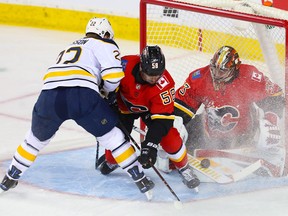 Calgary Flames goalie David Rittich makes a save on Buffalo Sabres' Johan Larsson at the Saddledome on Wednesday, Jan. 16, 2019.