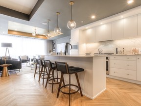 Concrete construction paired with high-end finishes such as chevron flooring and custom kichens are standard at the Gateway condo project in West District.