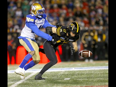 Winnipeg Blue Bombers, Marcus Sayles knocks the pass away from Hamilton Tiger-Cats, Luke Tasker in first half action at McMahon stadium during the 107th Grey Cup in Calgary on Sunday, November 24, 2019. Darren Makowichuk/Postmedia