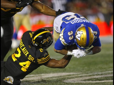 Winnipeg Blue Bombers, Andrew Harris  is taken down by the Hamilton Tiger-Cats, Delvin Breaux at McMahon stadium during the 107th Grey Cup in Calgary on Sunday, November 24, 2019. Darren Makowichuk/Postmedia