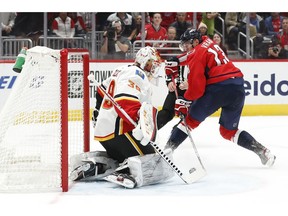 Nov 3, 2019; Washington, DC, USA; Washington Capitals left wing Jakub Vrana (13) scores a hat trick goal on Calgary Flames goaltender Cam Talbot (39) in the second period at Capital One Arena. Mandatory Credit: Geoff Burke-USA TODAY Sports ORG XMIT: USATSI-405211