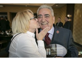Long-time sports columnist Larry Tucker gets a kiss from wife Lyn at his induction into the Football Writers of Canada Hall of Fame in Calgary, Ab., on Sunday November 24, 2019. Mike Drew/Postmedia