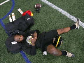 Hamilton Ti Cats Simoni Lawrence relaxes and checks messages on his phone following practice at the Macron Performance Centre in Calgary in preparation for Grey Cup 2019 Wednesday, November 20, 2019. Jim Wells/Postmedia