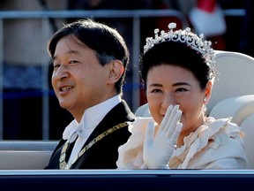 Japan's Emperor Naruhito and Empress Masako wave to well-wishers during their royal parade to mark the enthronement of Japanese Emperor Naruhito in Tokyo, Japan November 10, 2019.