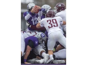 Western quarterback Chris Merchant tries to go over the pile but is stopped early in their Yates Cup game against the McMaster Marauders last Saturday at Western.  McMaster dominated the game winning 29-15. Photo by Mike Hensen/Postmedia.