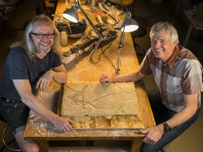 Michael Caldwell, professor in biological sciences and the department of earth and atmospheric sciences at the University of Alberta, and dinosaur paleontologist Phil Currie with the pterosaur specimen.