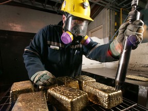 A worker cleans gold bars at the Red Lake gold mine in Balmertown, Ont.