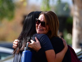 Women embrace in a nearby park after a shooting at Saugus High School in Santa Clarita, California, on Thursday, Nov. 14, 2019.