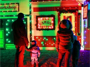 The Pituch family checks out a Christmas village part of the large Christmas lights display at Spruce Meadows on Sunday December 14, 2014. (Gavin Young/Calgary Herald) (For City section story by TBA) Trax# 00061190A