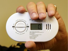 Fire prevention officer Tim Vanhecke of the Belleville Fire Department holds a carbon monoxide detector.