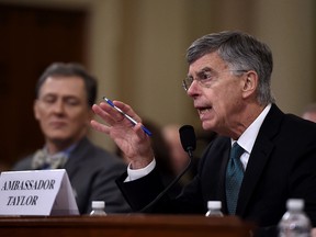 Top U.S. diplomat in Ukraine William Taylor, right, testifies during the House Intelligence Committee on Capitol Hill in Washington on Nov. 13, 2019, at the first public impeachment hearing of President Donald Trump.