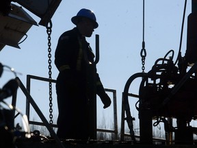 A oilfield worker on a rig near Drayton Valley. The Alberta government has lifted production quotas on new conventional oil wells.