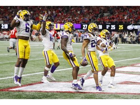 ATLANTA, GEORGIA - DECEMBER 07: Derek Stingley Jr. #24 of the LSU Tigers celebrates with teammates after intercepting a pass in the third quarter against the Georgia Bulldogs during the SEC Championship game at Mercedes-Benz Stadium on December 07, 2019 in Atlanta, Georgia.