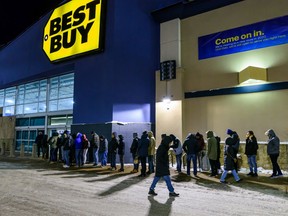 People wait in line outside the Sunridge Best Buy before the storeÕs 6 a.m. opening for Boxing Day on Thursday, December 26, 2019.