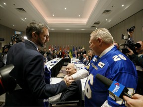 Sandy Silver, Yukon's premier, left, shakes hands with Doug Ford, Ontario's premier, during a Canada's Premiers meeting in Toronto, Ontario, Canada, on Monday, Dec. 2, 2019.