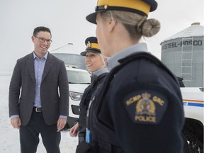 Doug Schweitzer, Minister of Justice stands with RCMP member Cst. Cheri-Lee Smith and Cst. Amanda Arneil in the yard of a Leduc area dairy farm. The government of Alberta announced on Wednesday that more than 500 RCMP positions in rural communities will be added in the next five years to combat crime on December 4, 2019.