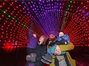 Mom, Lisa and Kurtis Rasmussen with Jacob, 2, and Evelyn, 4, check out the Zoo Lights in Calgary on Monday, November 25, 2019.