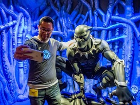 A guest takes a selfie at the Marvel Universe of Superheroes exhibit at Telus World of Science in Edmonton. Photo, Christine Mitchell