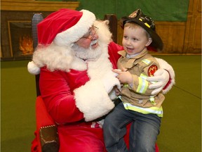 Jackson Steely, 3 yrs, meets Santa at the Calgary Firefighters 52nd annual Christmas party held at the Corral in Calgary on Sunday, December 15, 2019. Jackson, joined over 4,000 deserving Calgary children to celebrate the holidays with Calgary firefighters at the annual Calgary Firefighters Toy Association party, where they received donated gifts, enjoy a holiday lunch, entertainment and visit from Santa. Jim Wells/Postmedia