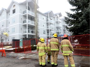 Firefighters were at the scene of the blaze on Saturday. Investigators suspect Friday's fire started on a rooftop patio.