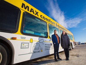 Asif Kurji, Calgary Transit's acting manager of transit planning and Anne Cataford, manager of major transit projects, stand next to a MAX Yellow bus on Monday, Dec. 16, 2019. The long-awaited rapid bus route will start operating in southwest Calgary on Dec. 23.