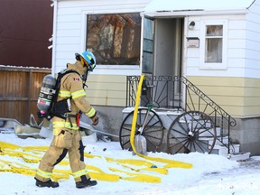 Calgary firefighters investigate the cause of a fire early Sunday morning in the 2400 blk of 6 Ave NW in Calgary on Sunday, December 15, 2019. No one was home at the time of the fire and according to CFD, the interior smoke alarms were activated. Jim Wells/Postmedia