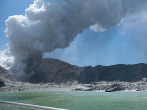 A photo posted to Twitter shows a volcano on White Island, new Zealand in the middle of an eruption, as tourists scramble to get off the island.