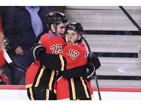 Dec 5, 2019; Calgary, Alberta, CAN; Calgary Flames left wing Johnny Gaudreau (13) celebrates with center Sean Monahan (23) after scoring a goal in the first period against the Buffalo Sabres at Scotiabank Saddledome. Mandatory Credit: Candice Ward-USA TODAY Sports ORG XMIT: USATSI-405439