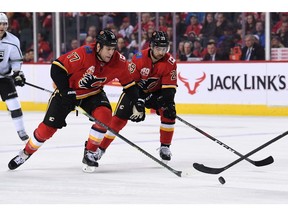 Dec 7, 2019; Calgary, Alberta, CAN; Calgary Flames left wing Milan Lucic (17) and center Dillon Dube (29) chase after the puck in the third period against the Los Angeles Kings at Scotiabank Saddledome. Flames won 4-3. Mandatory Credit: Candice Ward-USA TODAY Sports ORG XMIT: USATSI-405455