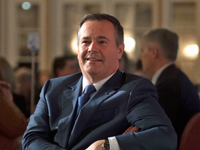 Alberta Premier Jason Kenney listens as he is introduced before speaking to a packed event of the Canadian Club of Ottawa on Monday.