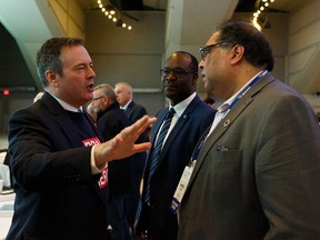 Premier Jason Kenney and Calgary Mayor Naheed Nenshi discuss a point at the Alberta Urban Municipalities Association convention in Edmonton on Sept. 27, 2019.