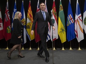 Finance Minister Bill Morneau and Associate Minister of Finance Mona Fortier prepare to speak to the media  before meeting with provincial finance ministers on Tuesday, Dec. 17, 2019 in Ottawa.
