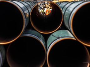 Pipe for the Trans Mountain pipeline is unloaded for construction.