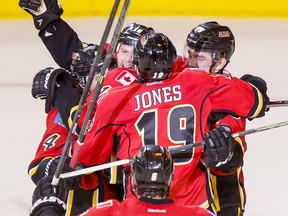 The Calgary Flames celebrate Matt Stajan's game-winning goal on the Vancouver Canucks during playoff action in Calgary, Alta., on Saturday, April 25, 2015.The Flames won 7-4 to advance to the second round of the Stanley Cup playoffs. Lyle Aspinall/Calgary Sun/Postmedia Network
