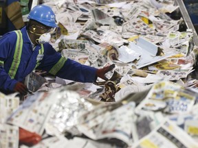 Workers sort recycling at Edmonton Waste Management Centre in December 2017.